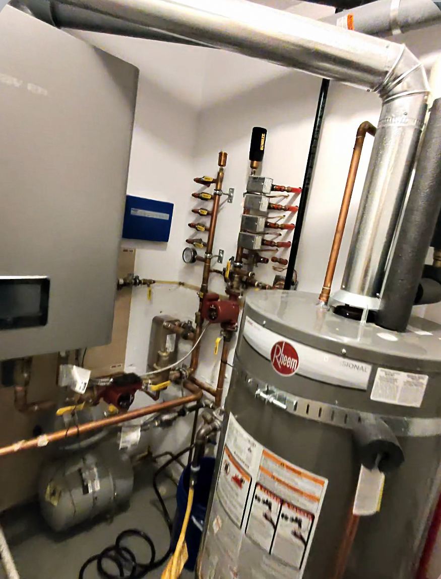 Boiler room with water heater and hydronic piping